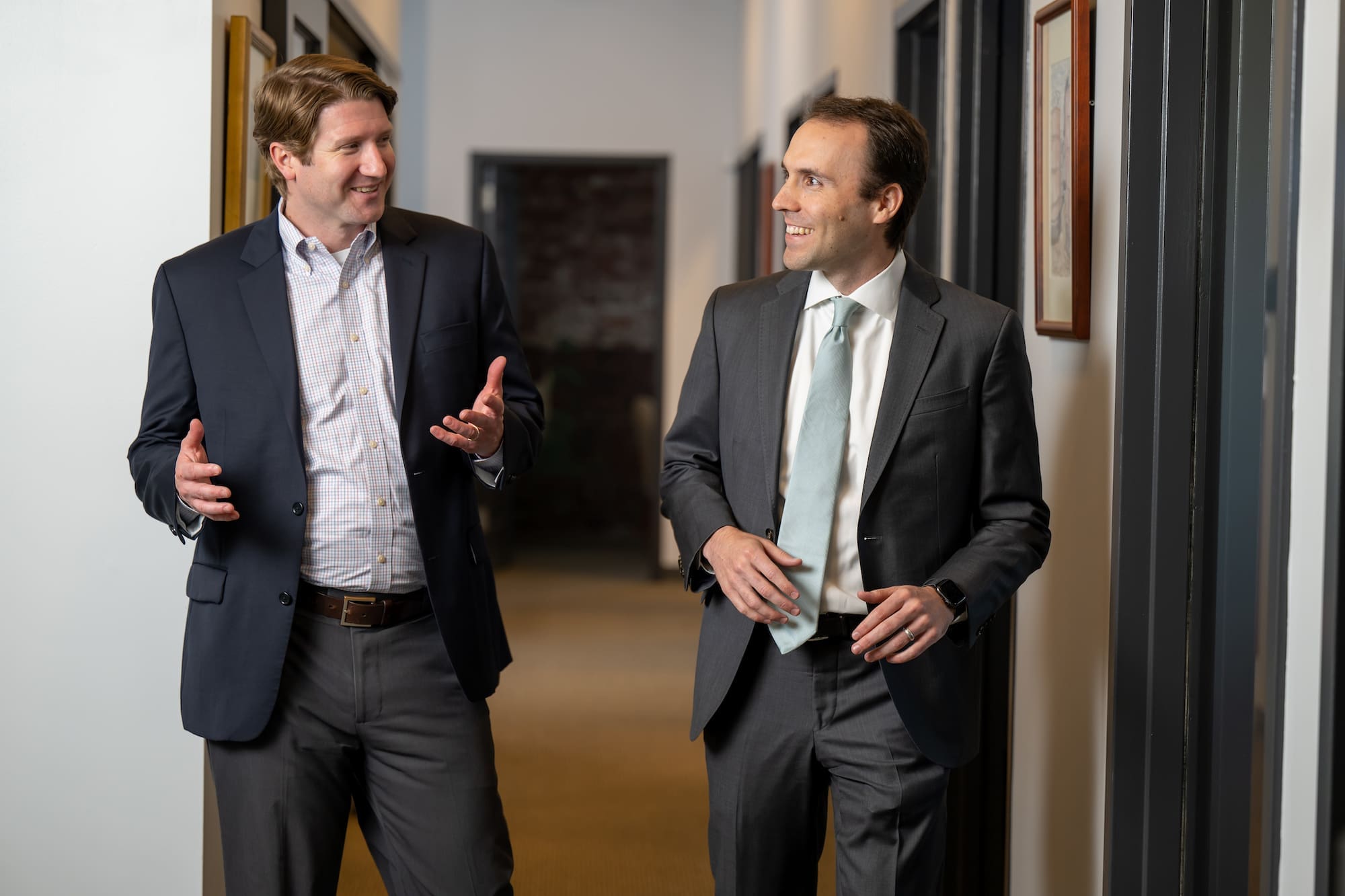 Two men wearing suits have a conversation to illustrate what CCA clients have to say about our approach 